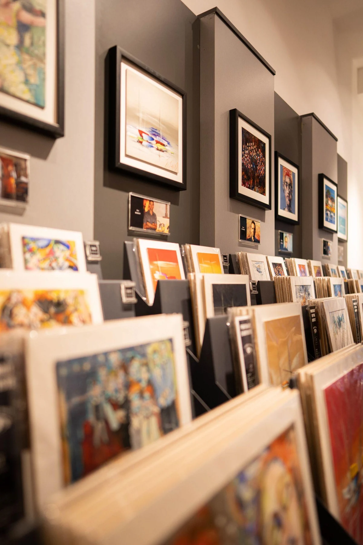 A display of varied framed prints offers a first art buyer several subjects and formats to compare.